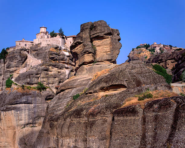 Perched atop towering rock pillars in central Greece, the Varlaam and Great Meteoron Monasteries are two of the most prominent Eastern Orthodox sanctuaries in Meteora.