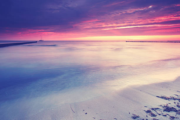 istock calm sea on a summer evening, awesome sunset sky with vibrant colors 2219259548