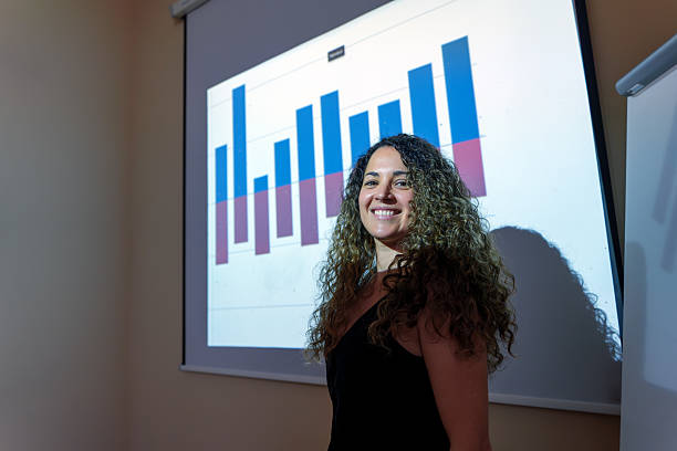 istock Young businesswoman smiling and presenting positive data charts 2219259551
