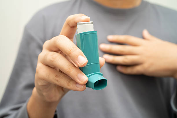 istock Asthma and chronic obstructive pulmonary disease COPD, Asian young man using metered dose inhaler MDI. 2219260633