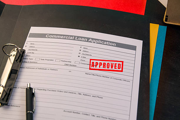 istock Commercial loan application with approved stamp on desk 2219261924