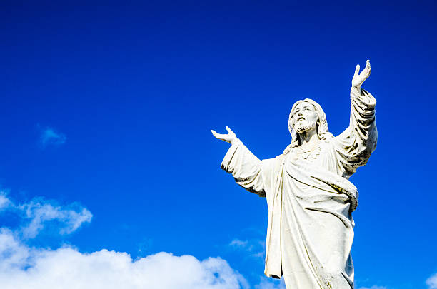 istock Jesus Christ statue standing against the blue sky. 2219262088