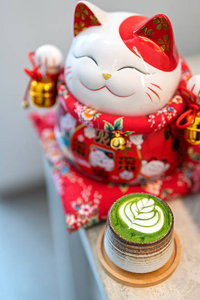 istock Matcha Latte with Maneki Neko Figurine in a Japanese-Inspired Setting 2219262216
