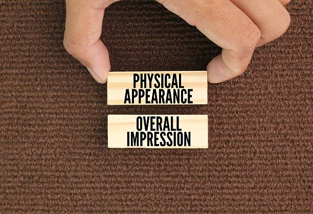 istock Wood with the words physical appearance and overall impression. Physical appearance, including clothing, grooming, and body language, plays a significant role in shaping first impressions 2219263110