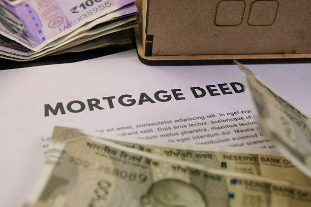 istock Important mortgage deed paperwork and Indian currency notes 2219264851