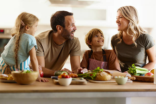 istock Happy family talking while preparing healthy meal in the kitchen. 2219264942