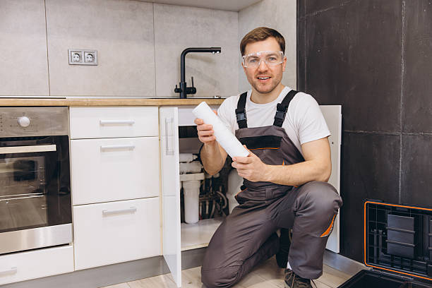 istock Plumber Replacing Water Filter Cartridge in Kitchen Sink 2219267043
