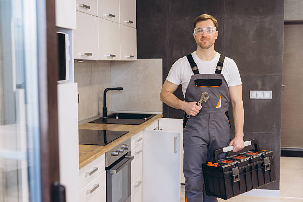 istock Plumber holding wrench and toolbox in kitchen 2219267080