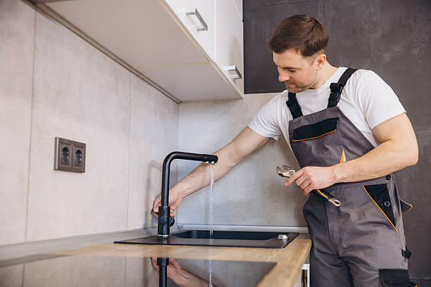 istock Plumber checking water flow after installing kitchen faucet 2219267091