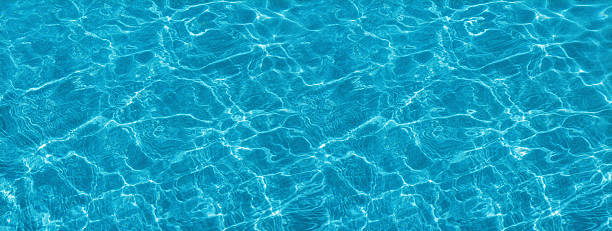 istock Turquoise and blurry sea waves. Dark grainy background. 2219268752