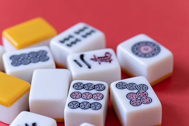 istock Mahjong tiles lined up on a red background 2219271343
