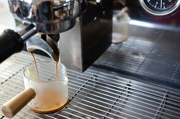 istock Coffee flowing from Portafilters being brewed in an espresso machine. 2219272494