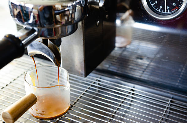istock Coffee flowing from Portafilters being brewed in an espresso machine. 2219273051