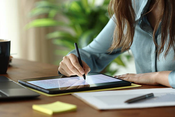 Employee working handwriting on digital tablet stock photo