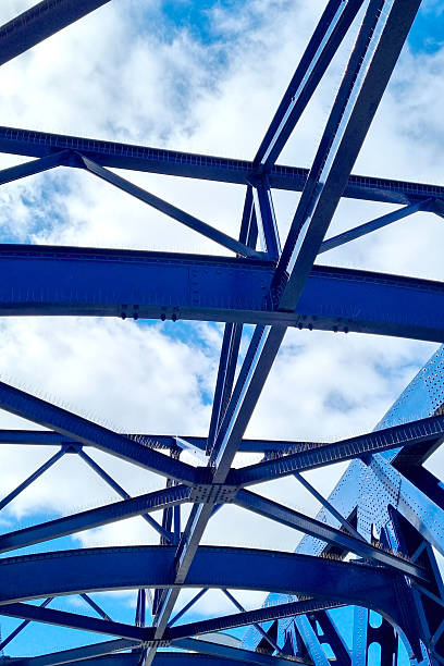 istock Architectural Structure and Design of a Blue Steel Bridge Against a Vibrant Sky 2219274036