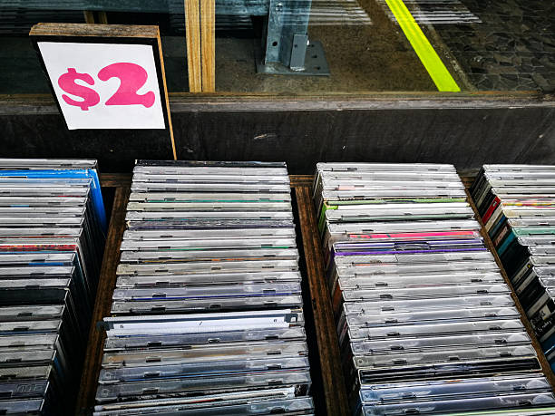 Secondhand CD music albums sale for 2 dollars each, at discount store.