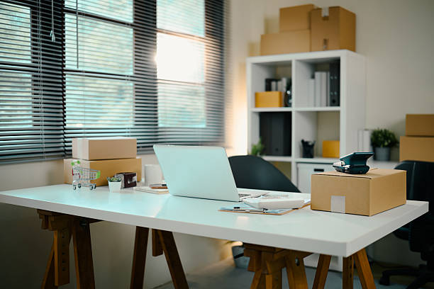 istock E-commerce home office with laptop, shipping parcels, and packaging tools on a white desk 2219276895
