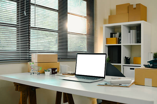 istock E-commerce home office with laptop, shipping parcels, and packaging tools on a white desk 2219276903