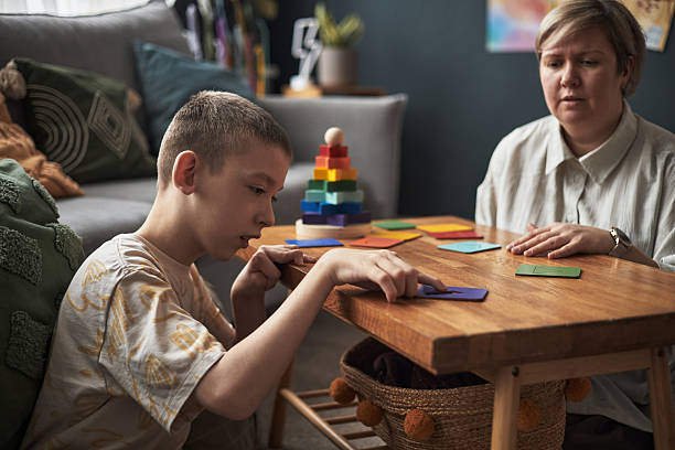istock Engaging in Educational Activity at Wooden Table at Home 2219280734