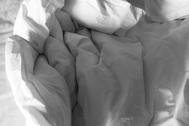 istock Clean crumpled white bed sheet and pillow after use. 2219282852