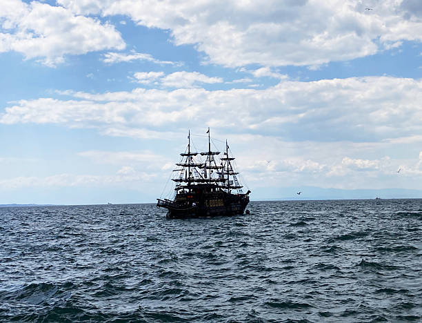 istock Mediterranean Pirate Ship Sailing on the Open Sea Under a Cloudy Blue Sky 2219283872
