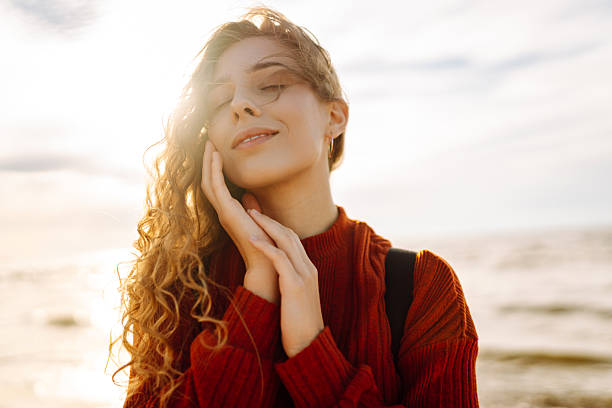 istock Traveler with backpack standing on sunset beach, feeling freedom. 2219285439