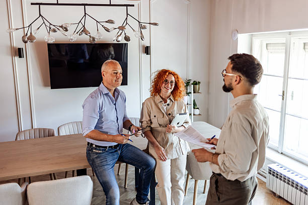 Couple Meeting With Creative Professional in Contemporary Home Interior Setting