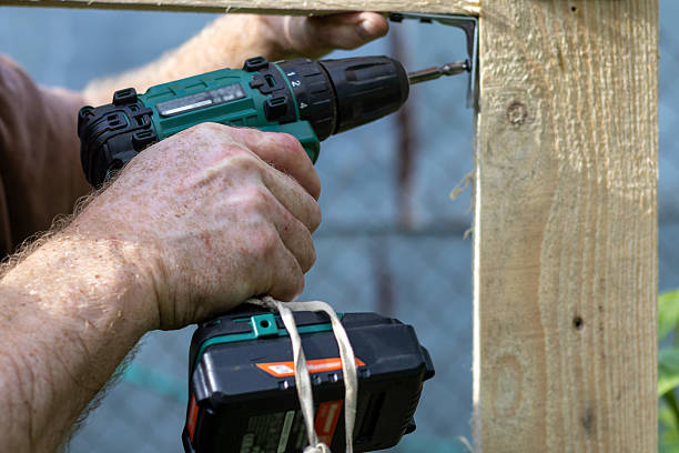 istock Hands of man using drill to assemble wooden structure. Close-up 2219289012