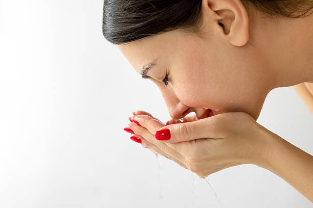 Female washing her face showing positive emotion