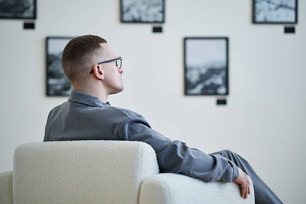 istock Man Sitting on Chair in Art Gallery 2219291760