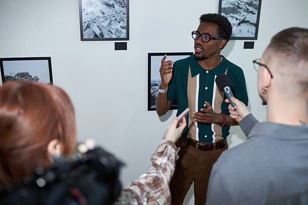 istock Discussing Art Exhibition in Front of Media 2219291779