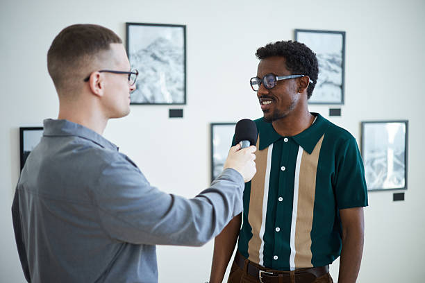 Conducting Interview with Smiling Man in Art Gallery