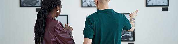 istock Observing Art Exhibition in Modern Gallery Setting 2219291816
