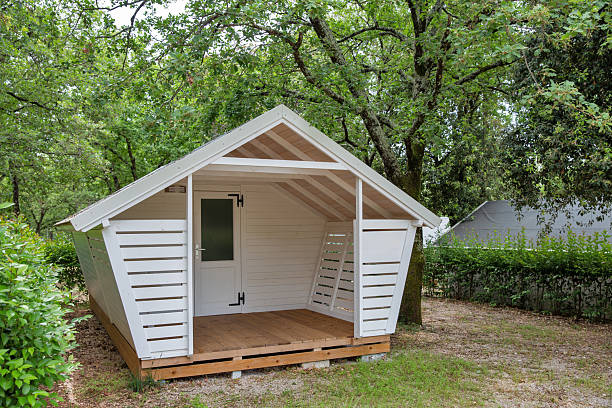 istock Small white wooden cabin in forest. 2219293218