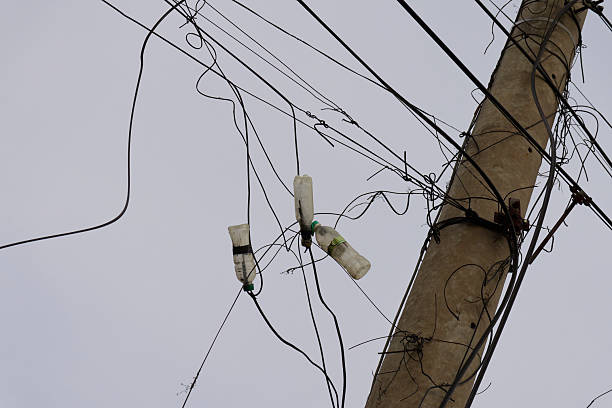 istock Urban Entropy Plastic Bottles Entangled in Power Lines Overhead Wires Cityscape 2219293600