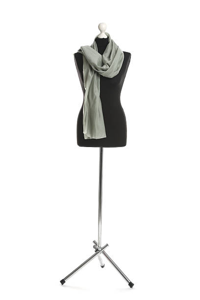 Draping grey fabric on female mannequin against white background