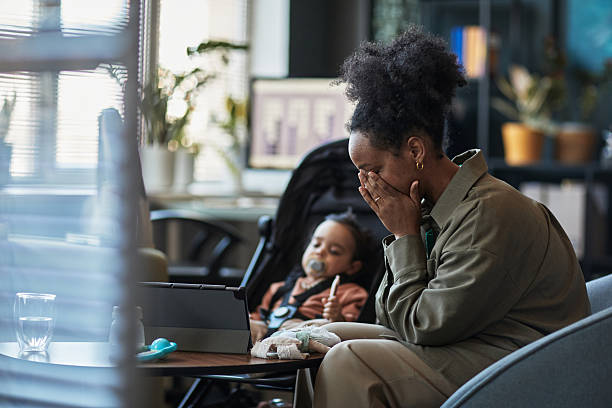 Child with her mother in modern office space, child playing with toy as mother focuses on her. Scene shows bond between family members within workspace
