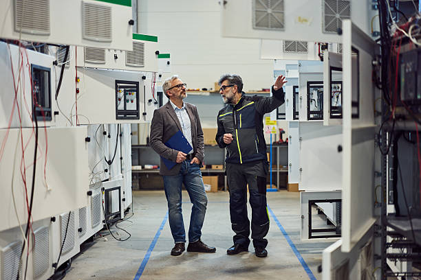 istock Two Engineers Discussing Machinery Development on a Factory Production Floor 2219297105