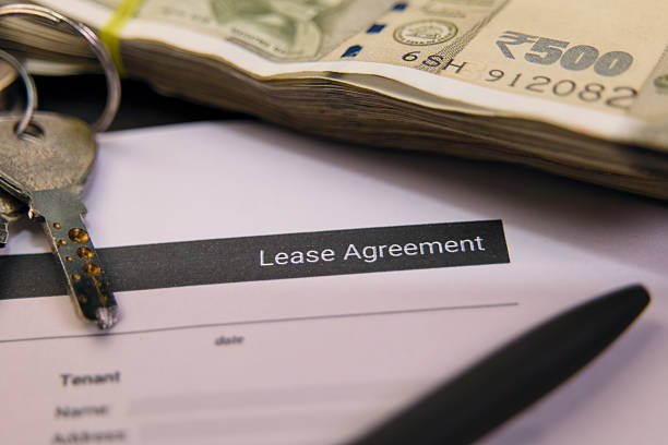 istock Lease agreement with cash and keys on a table 2219297807