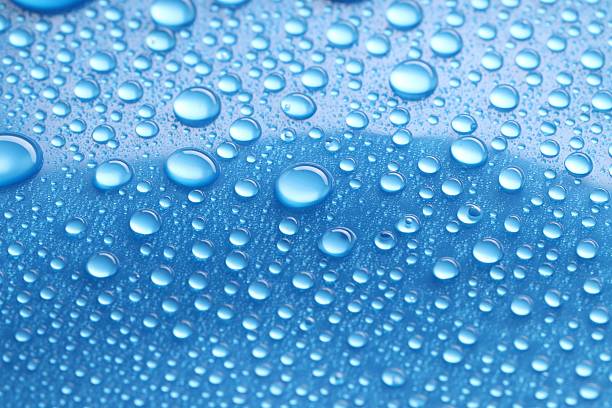 istock Water drops on blue background, closeup view 2219300534