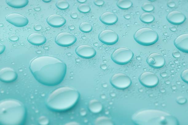istock Water drops on turquoise background, closeup view 2219300660
