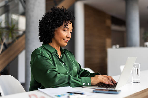 istock Professional Woman Working on Laptop in Modern Office Setting 2219301521