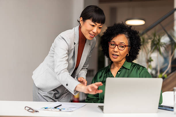 istock Two Professionals Collaborating on a Laptop at a Workspace 2219301640