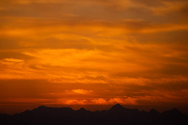 Beautiful Sunset With Orange Sky and Silhouetted Mountain Range