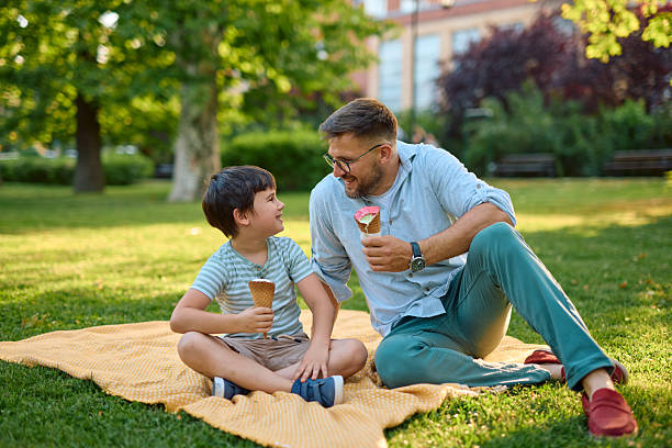 istock Father and son enjoying ice cream in the park 2219302776