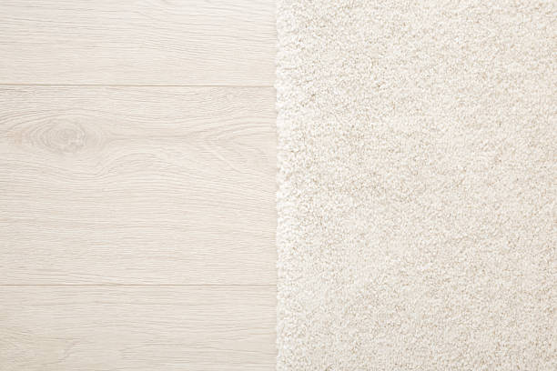 istock White new fluffy home carpet on light color laminate background. Closeup. Two sides. Top down view. 2219303851