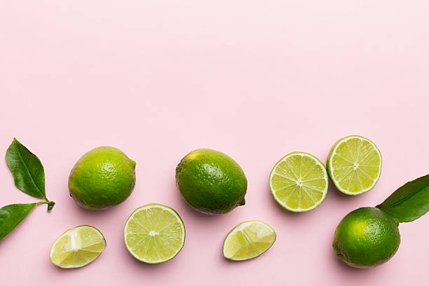 istock Lime fruits with green leaf and cut in half slice isolated on white background. Top view. Flat lay with copy space 2219304178