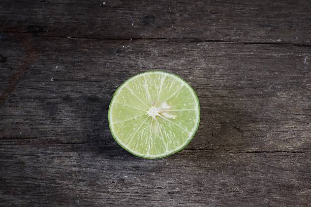 istock Green lime on wood background 2219304291