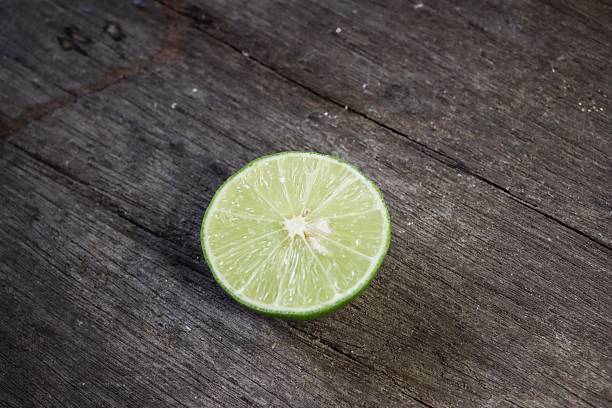 istock Green lime on wood background 2219304293
