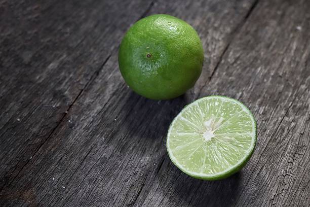 istock Green lime on wood background 2219304295